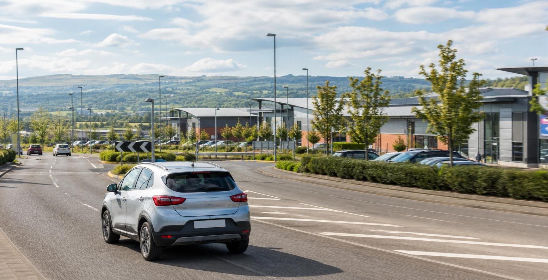 Compact hire car on a regional road near business units in Sheffield